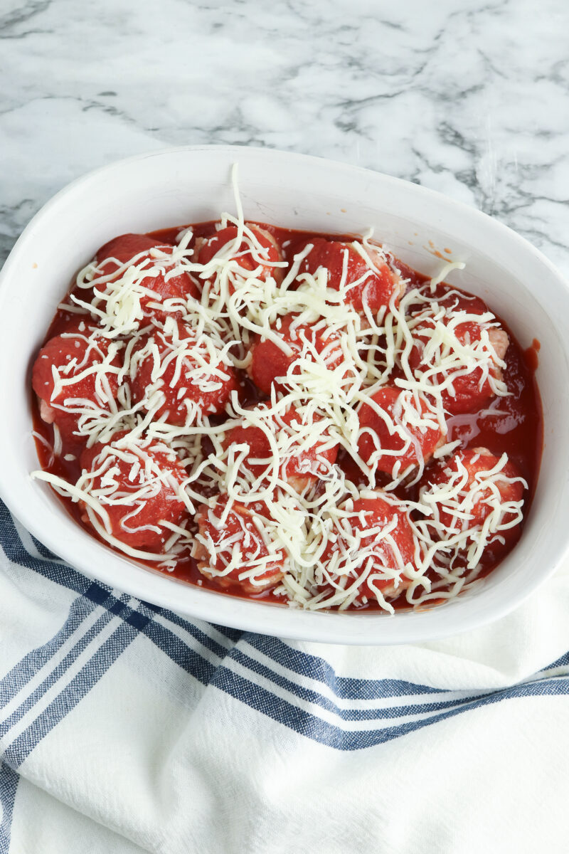 Meatballs topped with tomato sauce & shredded cheese